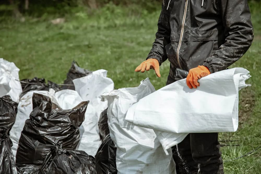 Person in gloves sorting trash.